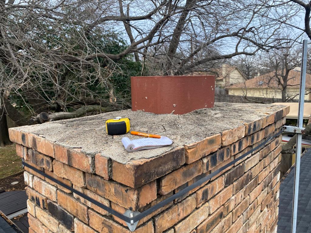 Notepad and measuring tape on chimney